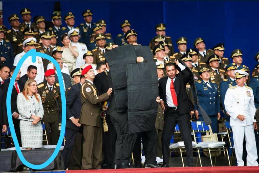 Protecting the President behind protecting shields deployed by security. The first lady is in blue circle.